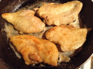 Floured Chicken frying in the olive oil, butter and lemon sauce